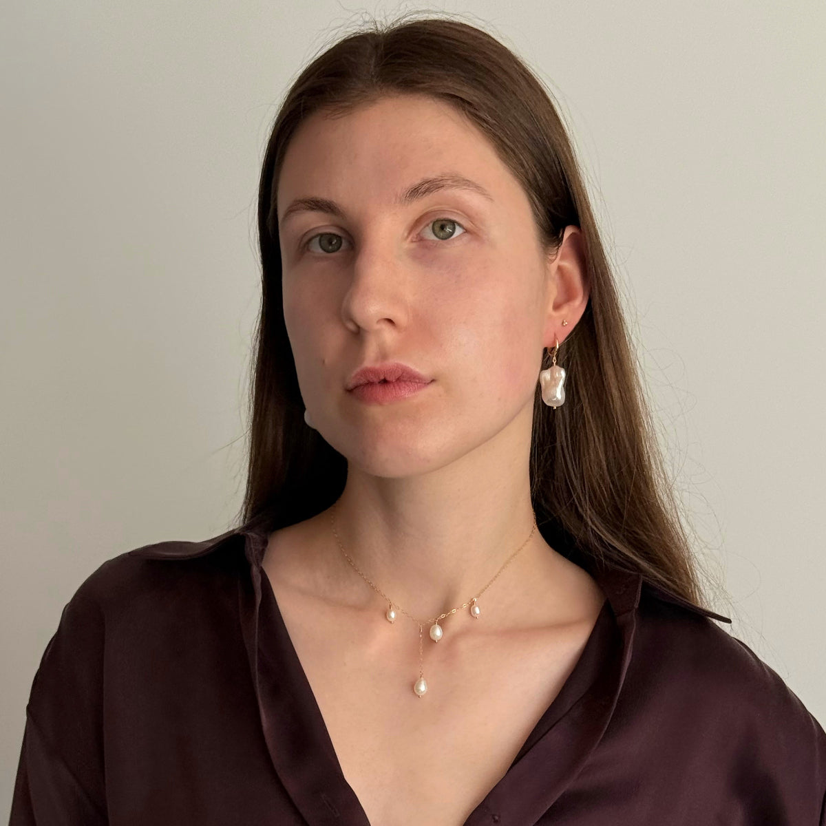 Woman wearing baroque pearl earrings and pearl necklace