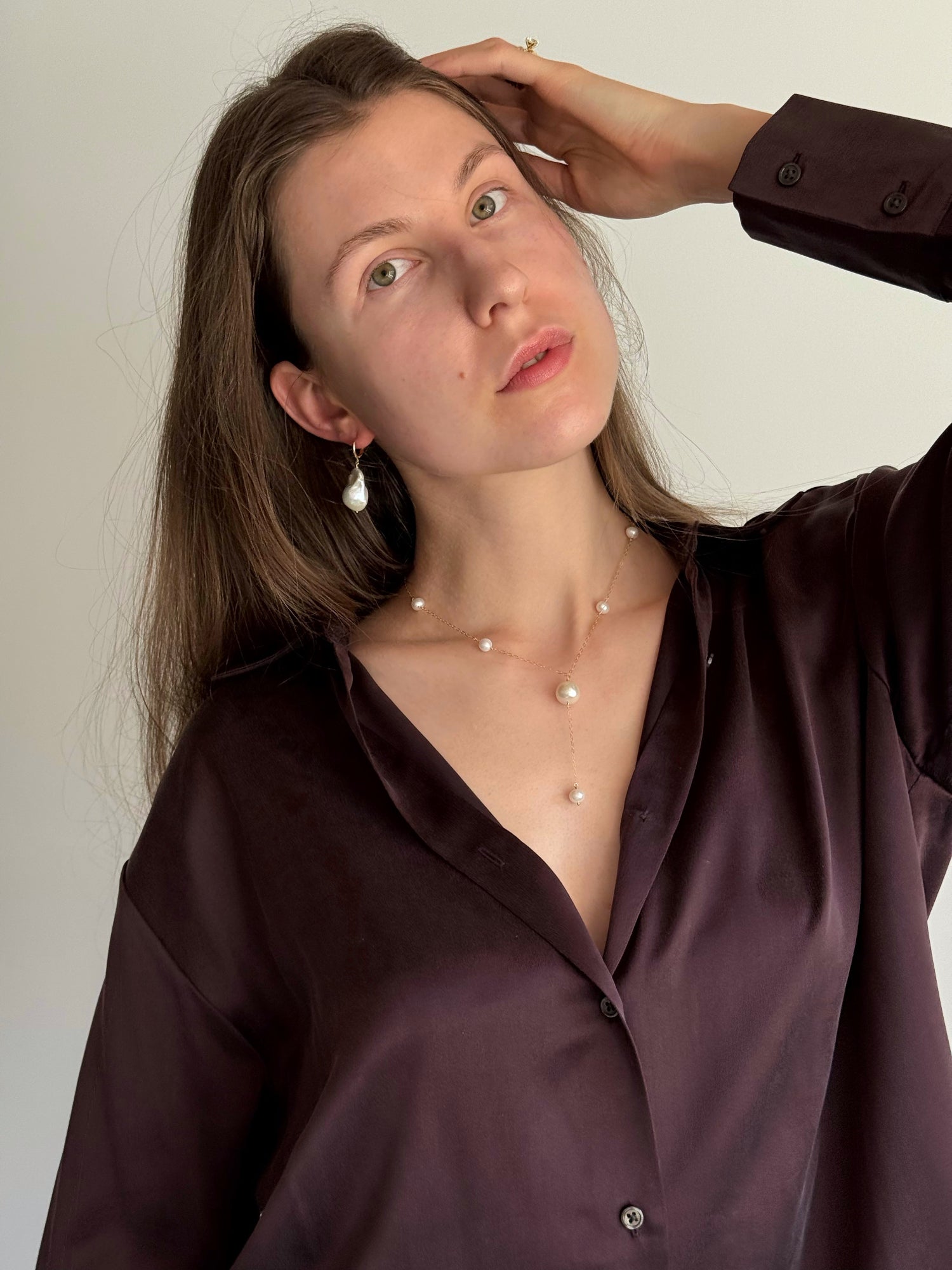 Statement pearl necklace styled on model with minimalist outfit