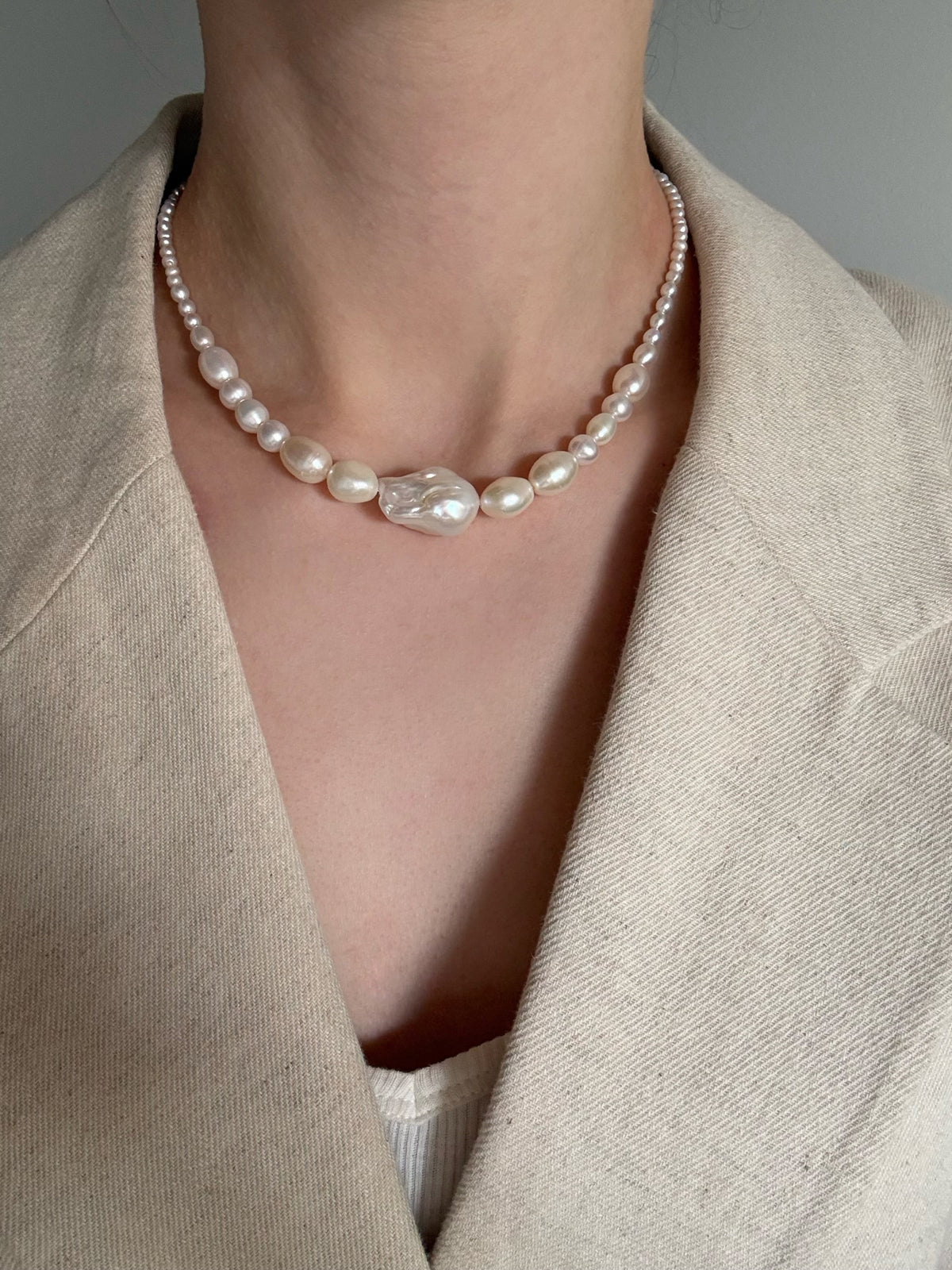 A graduating baroque freshwater pearl necklace with a large centre pearl and 14k gold-filled findings. Made to order in Wellington. 40cm + extension.