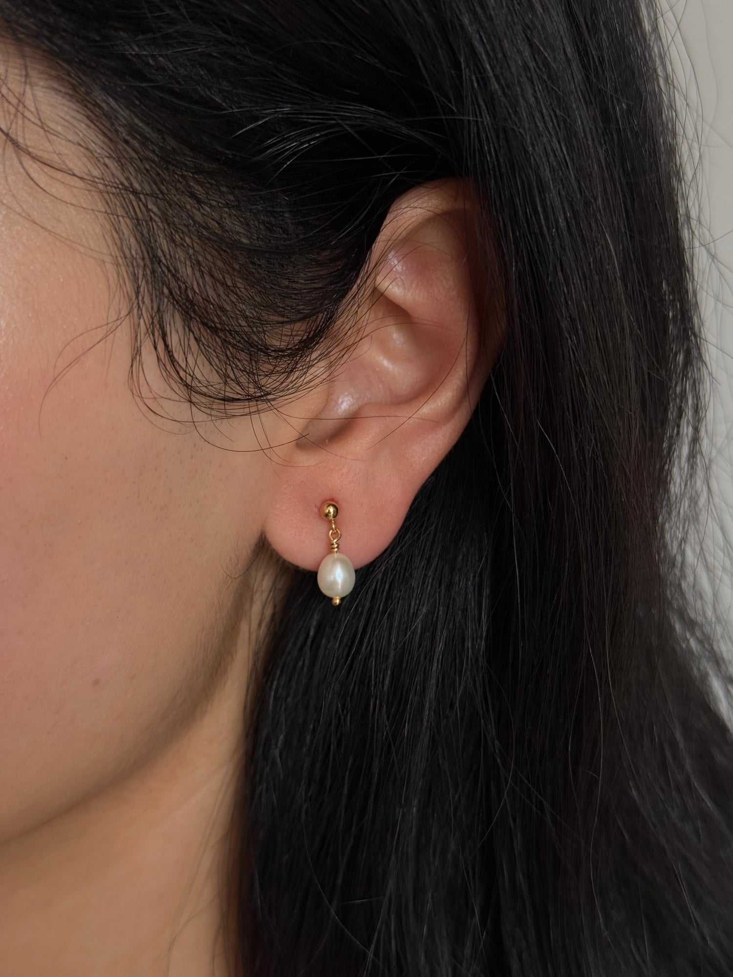 Close up of gold filled pearl stud with suspended freshwater pearl