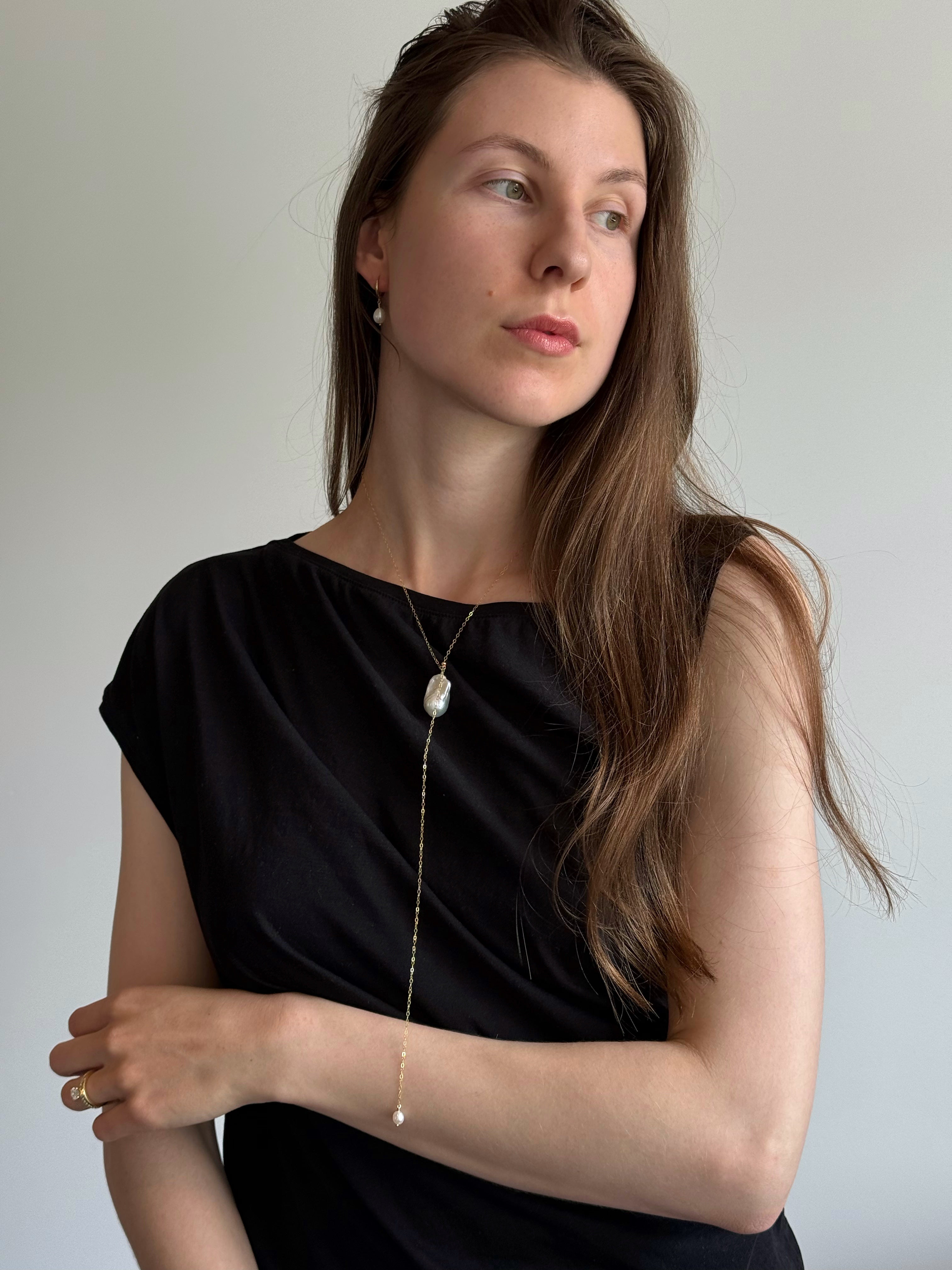 Everyday pearl necklace styled with neutral outfit and soft neckline