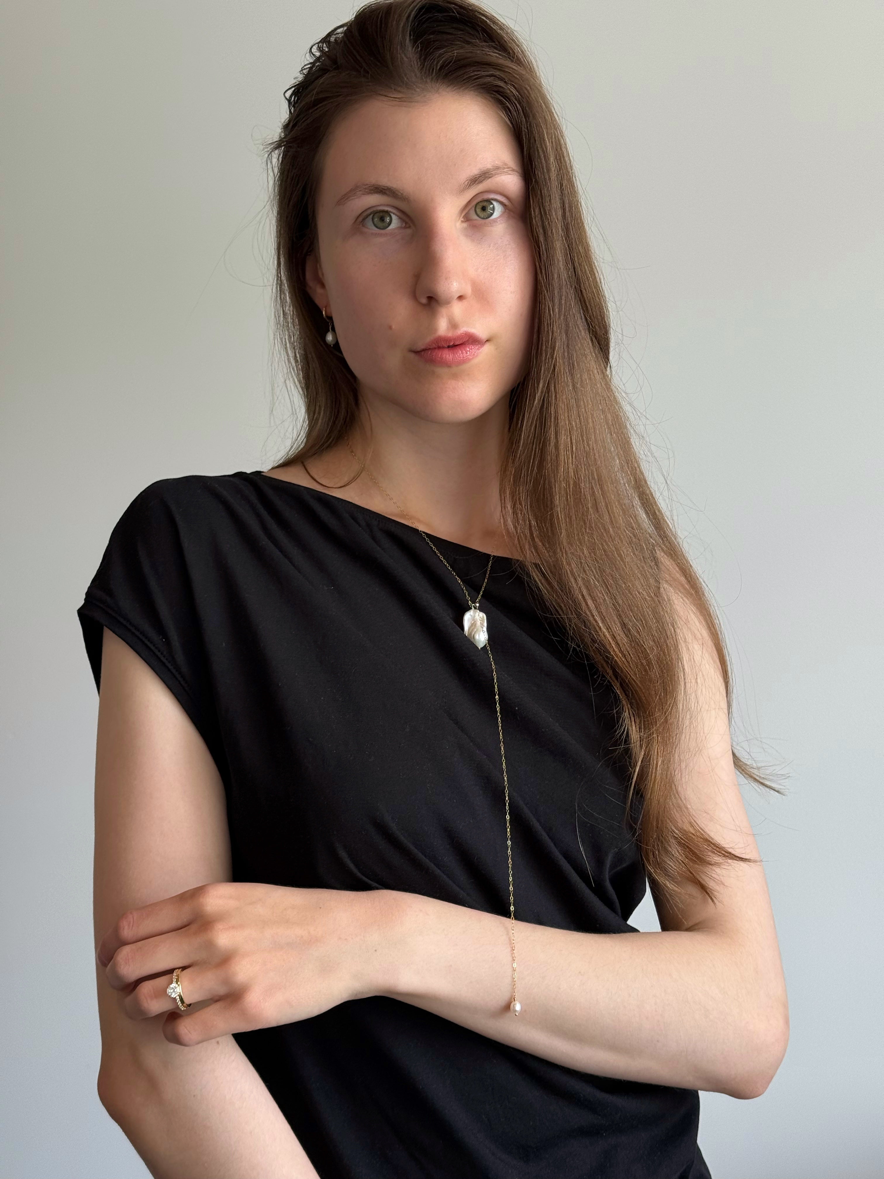 Baroque pearl slider necklace worn layered on model