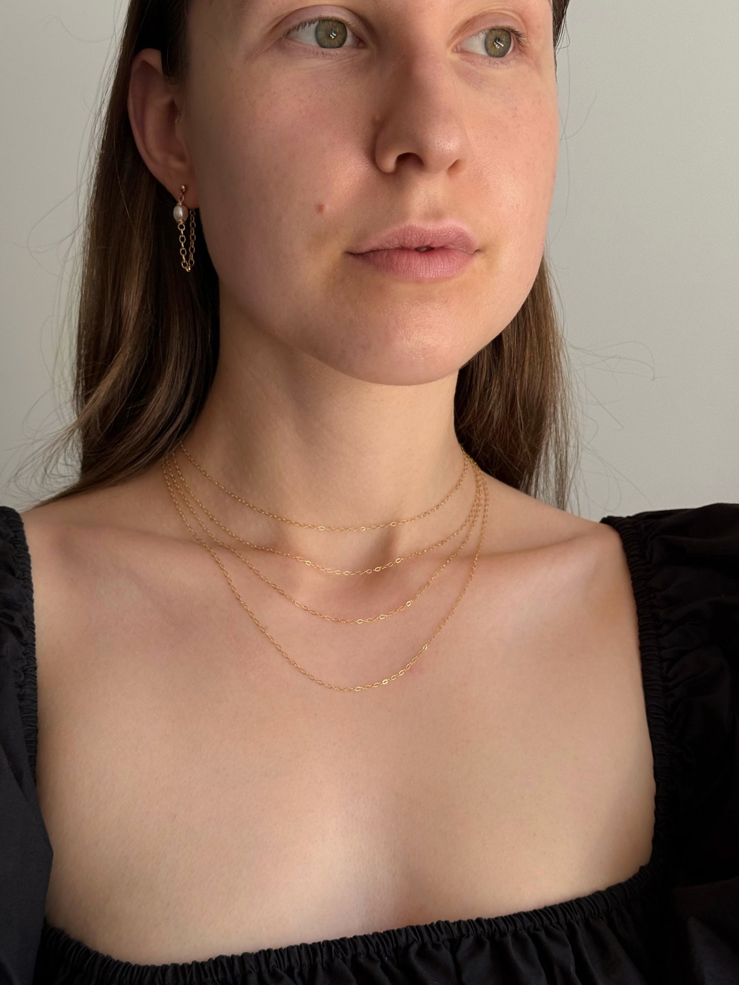 Model wearing delicate gold-filled pearl drop earrings