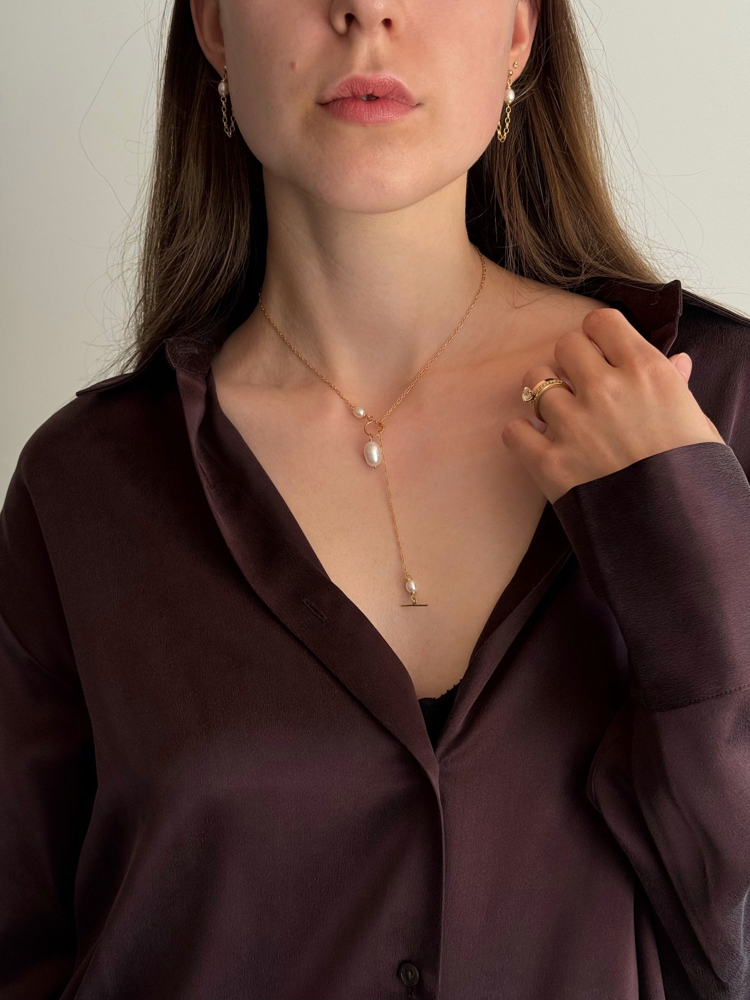 Model wearing delicate gold-filled pearl drop earrings