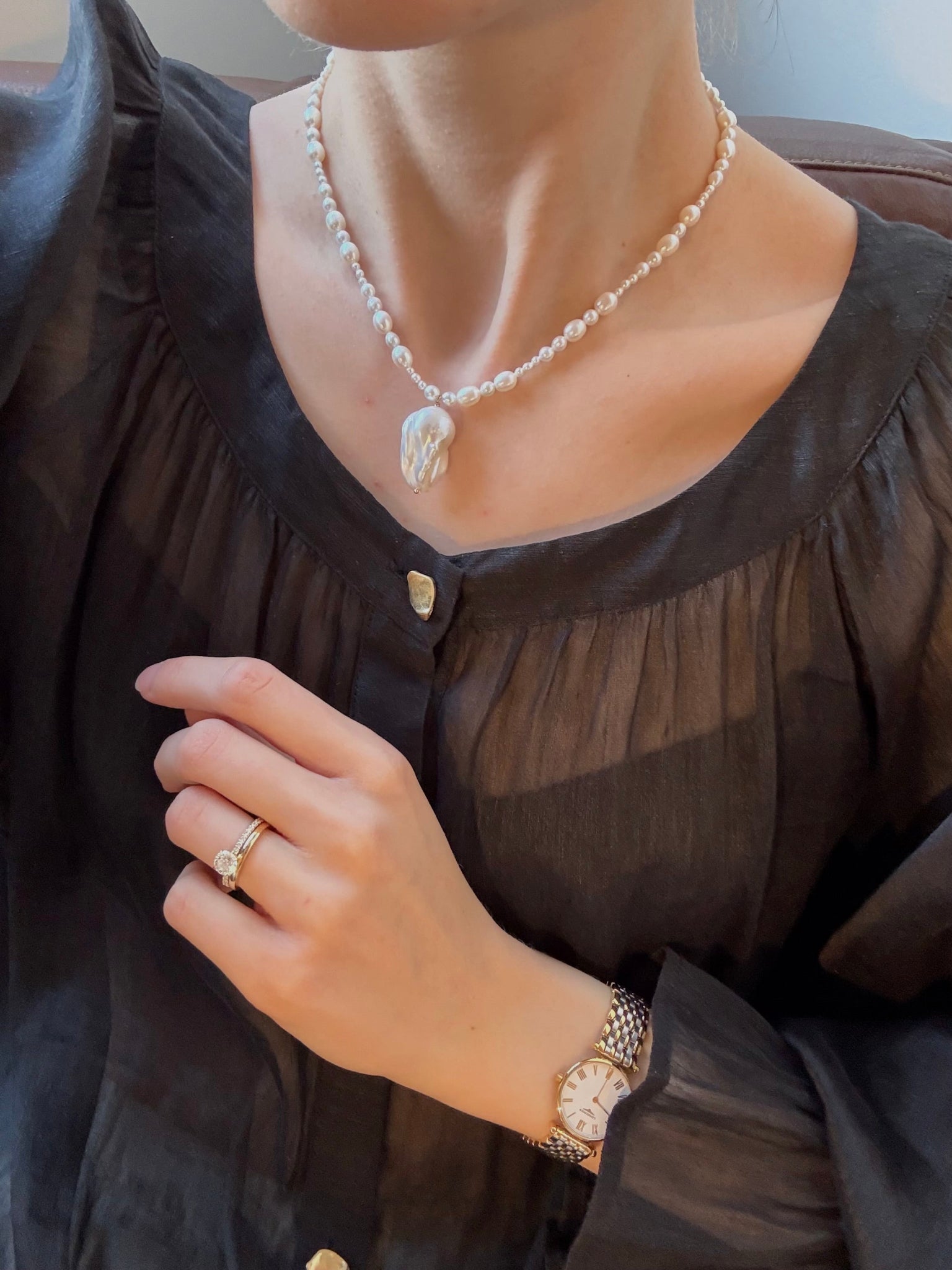 A graduated freshwater pearl necklace with a sculptural baroque pendant. 14k gold-filled findings, made to order in Wellington, New Zealand.