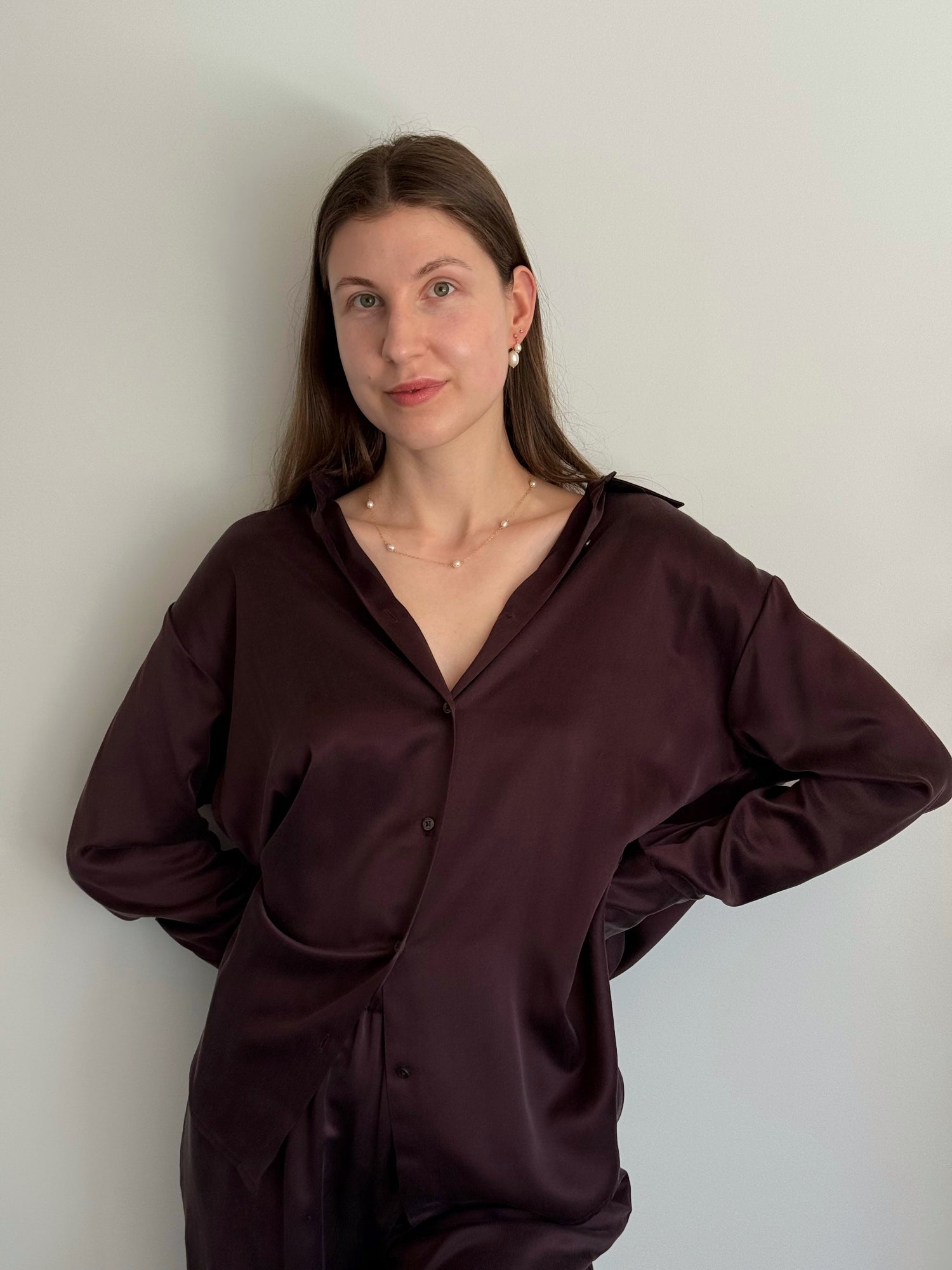 Model wearing floating pearl necklace and double-pearl earrings