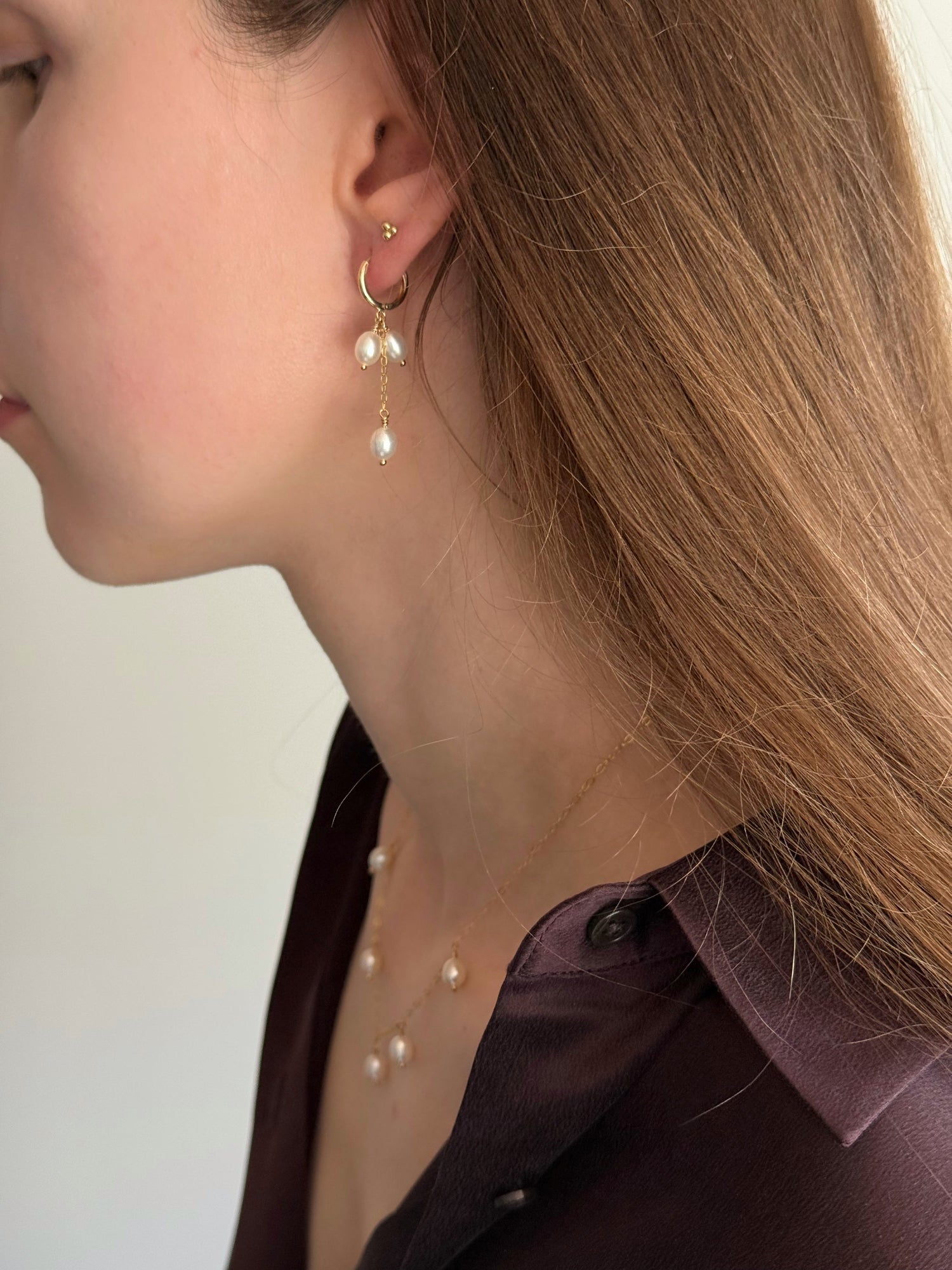 Gold-filled hoop earrings with two short pearls and one long drop