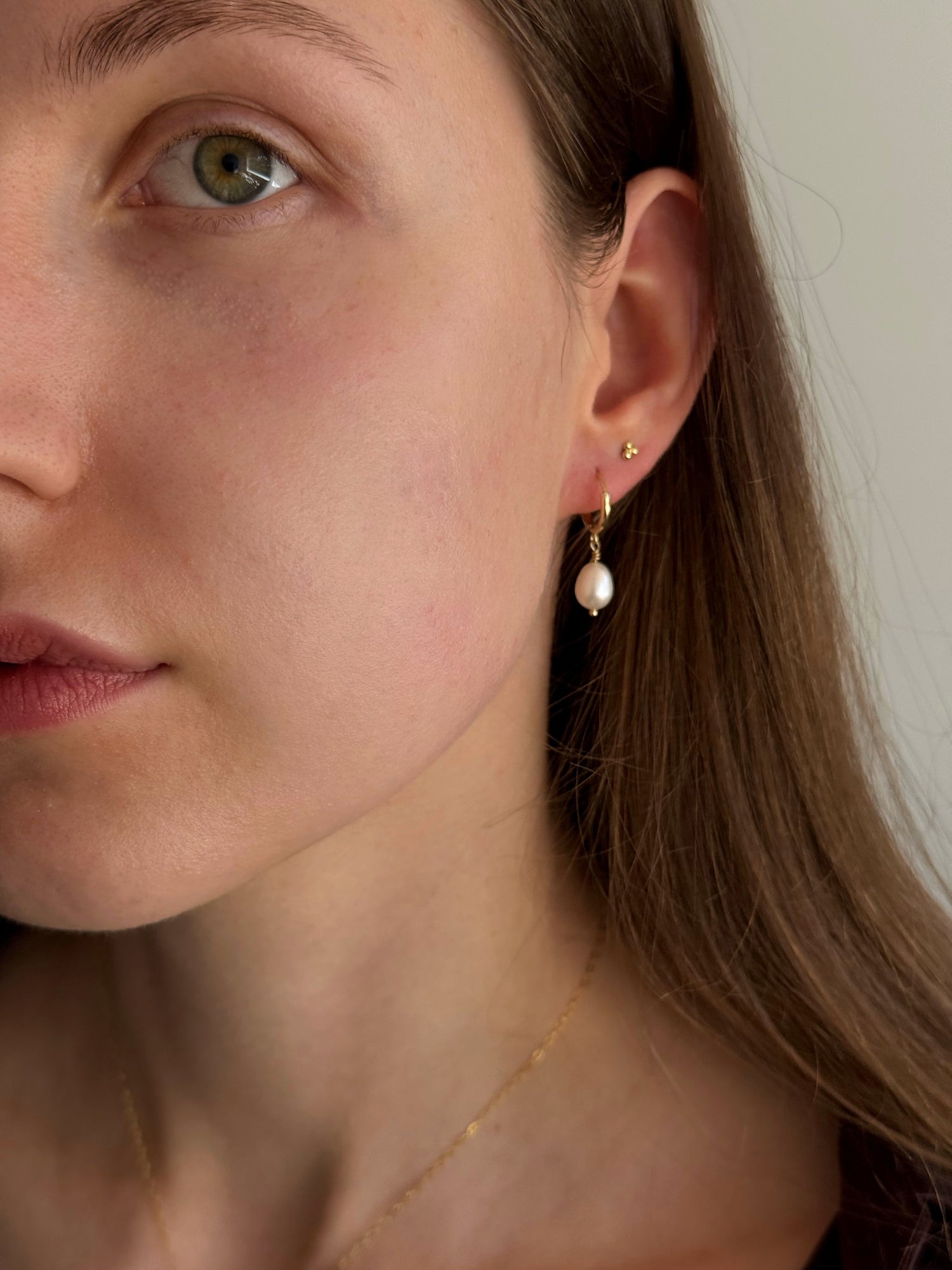 Close-up of freshwater pearl on small gold-filled hoop