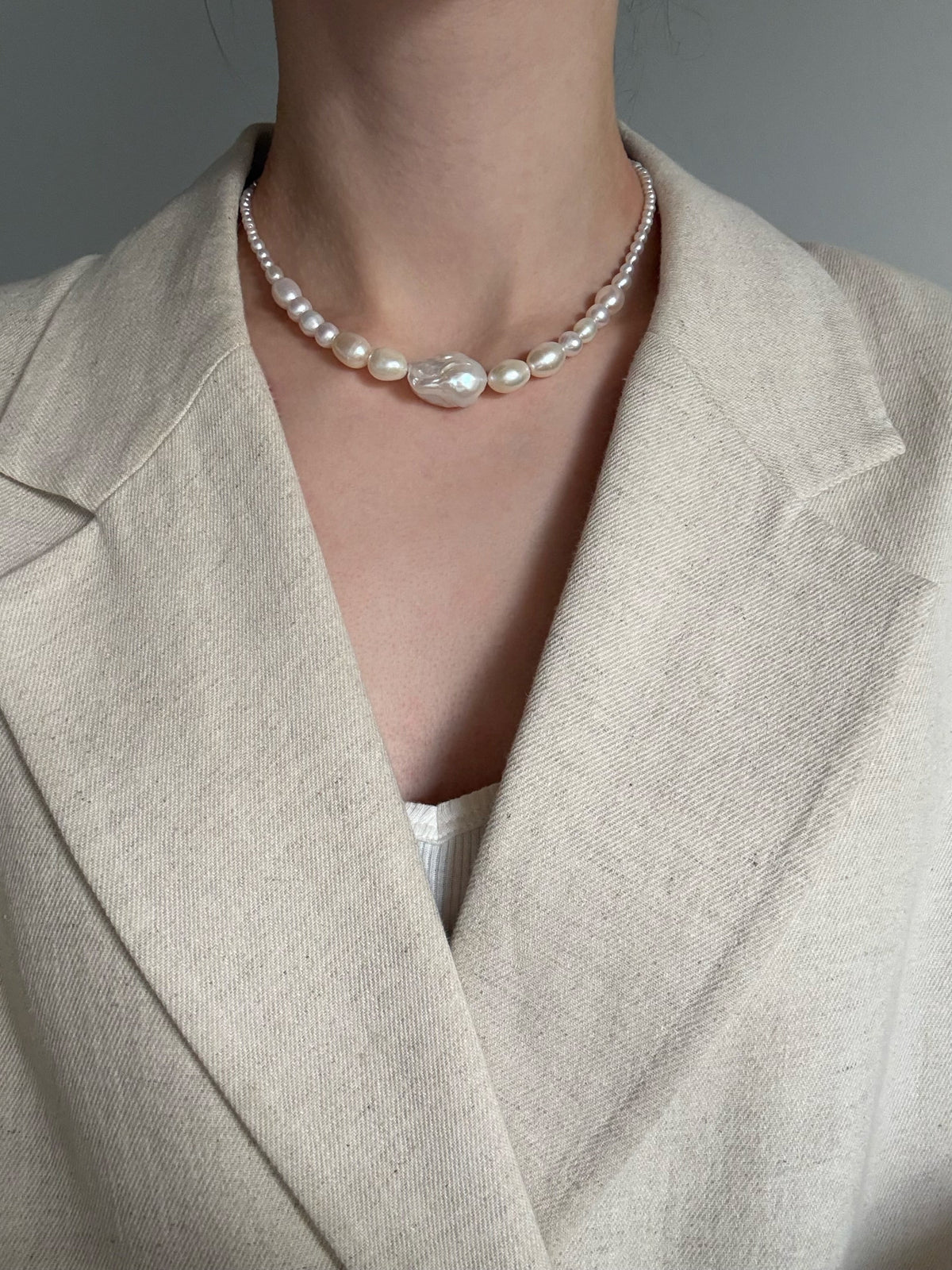 A graduating baroque freshwater pearl necklace with a large centre pearl and 14k gold-filled findings. Made to order in Wellington. 40cm + extension.