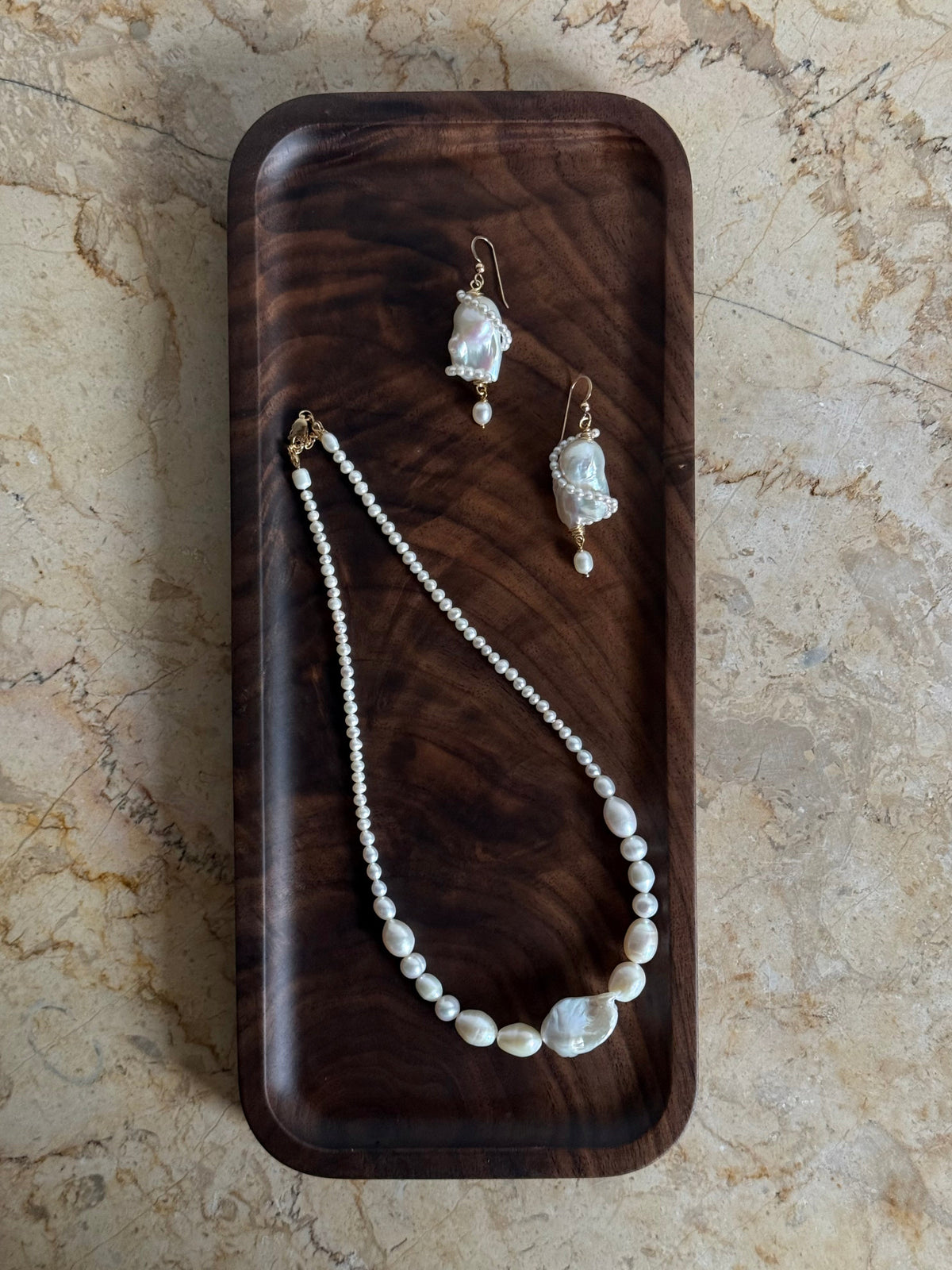 A graduating baroque freshwater pearl necklace with a large centre pearl and 14k gold-filled findings. Made to order in Wellington. 40cm + extension.