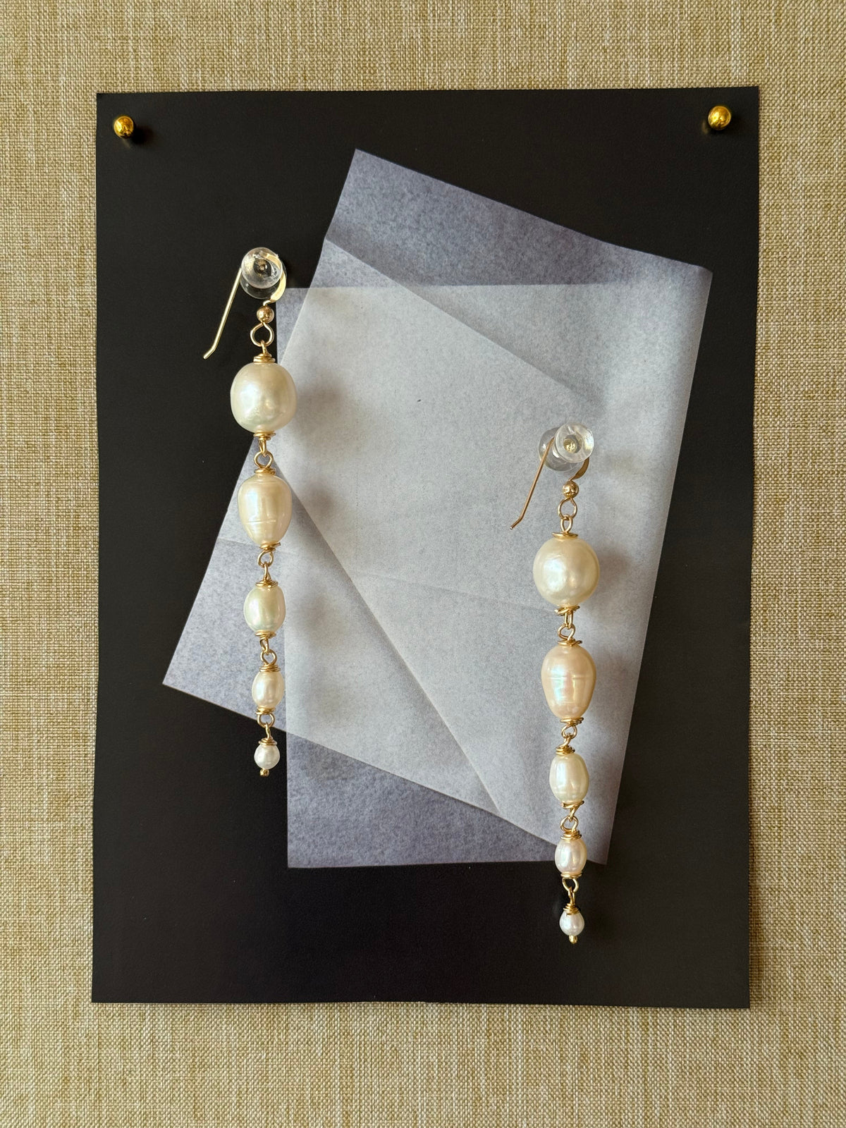 Graduating freshwater pearl drop earrings, 9cm, wire-wrapped in 14k gold-filled. Four pearls from 15mm to 5mm. Made to order in Wellington, New Zealand.