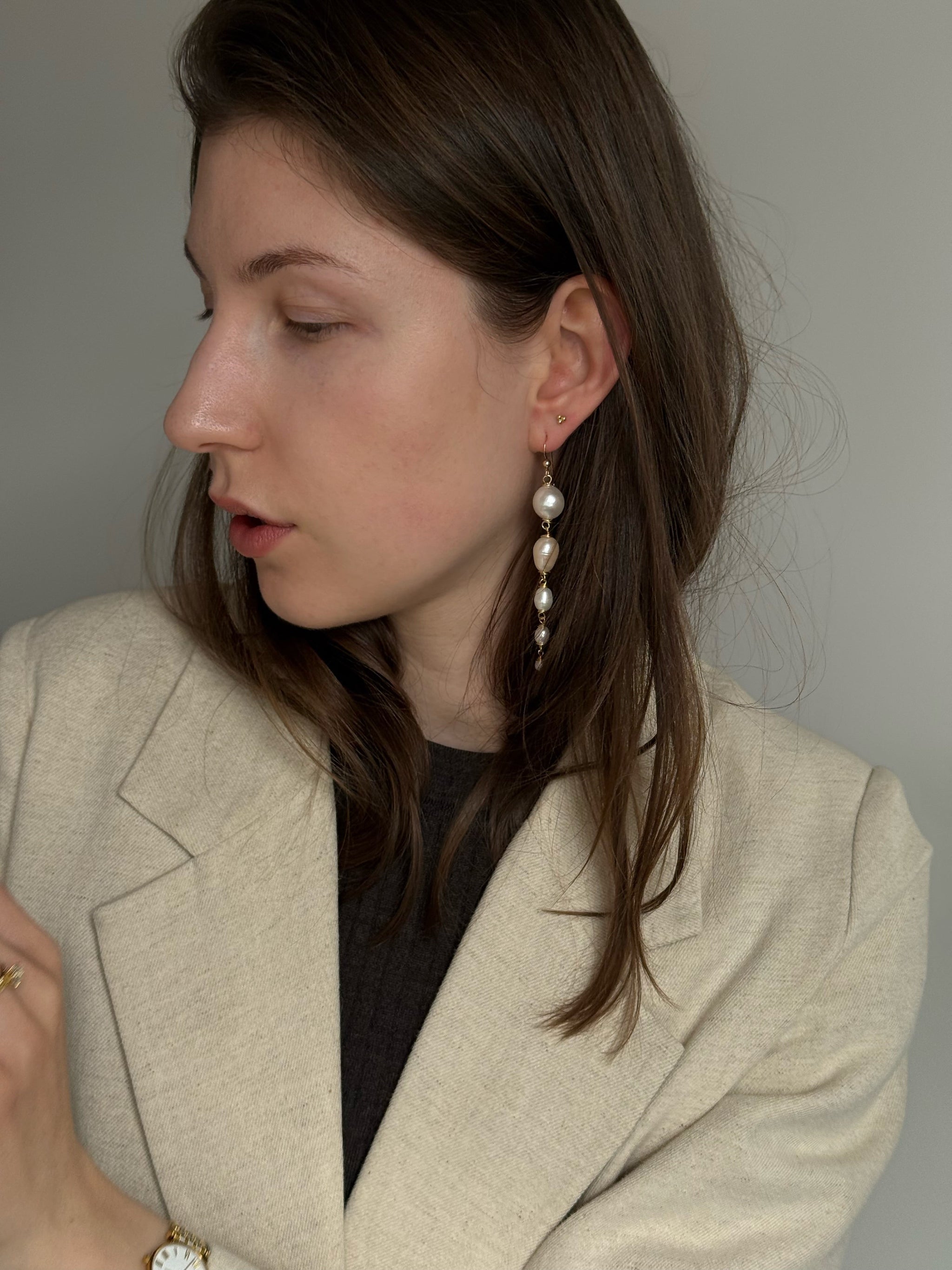 Graduating freshwater pearl drop earrings, 9cm, wire-wrapped in 14k gold-filled. Four pearls from 15mm to 5mm. Made to order in Wellington, New Zealand.
